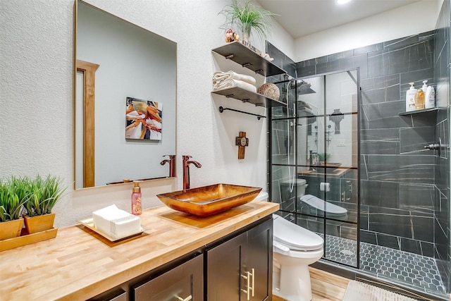 bathroom featuring hardwood / wood-style flooring, vanity, toilet, and a shower with shower door