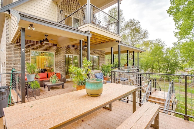 wooden deck with ceiling fan and an outdoor hangout area