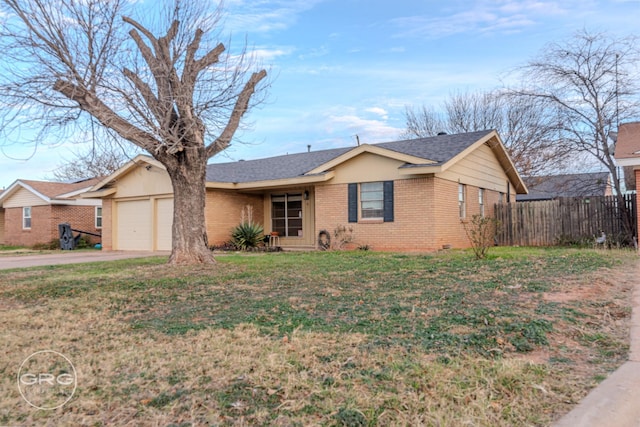 single story home with a garage and a front lawn