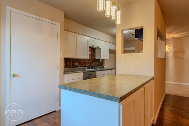 kitchen featuring backsplash, white cabinetry, dark hardwood / wood-style flooring, and hanging light fixtures