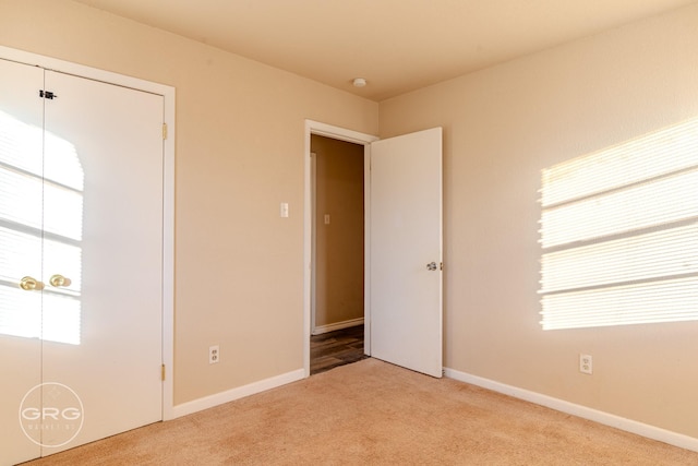 unfurnished bedroom featuring light colored carpet