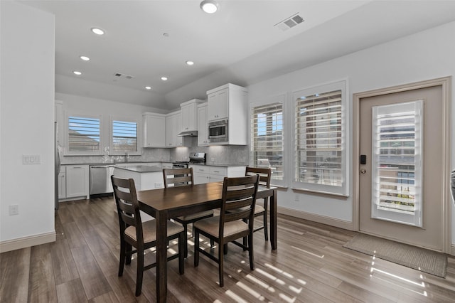 dining area featuring a wealth of natural light and light hardwood / wood-style flooring