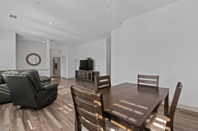 dining area with hardwood / wood-style flooring