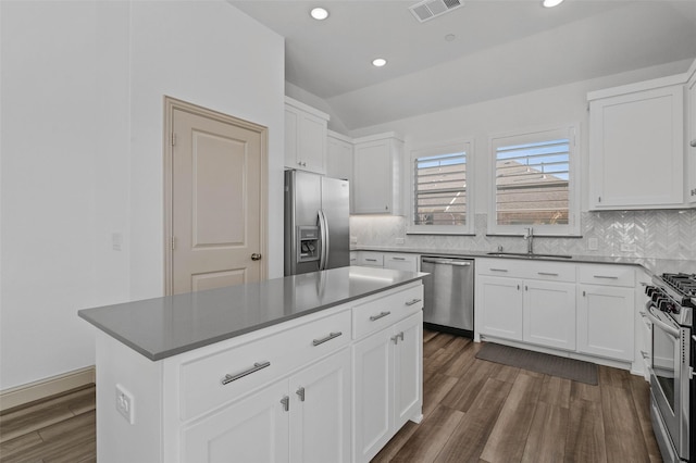 kitchen with white cabinets, a center island, and appliances with stainless steel finishes