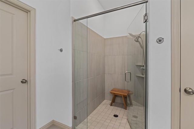 bathroom with a shower with door