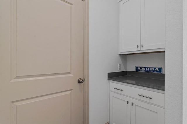 bar featuring white cabinets