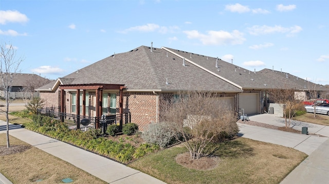 exterior space featuring a garage and a pergola