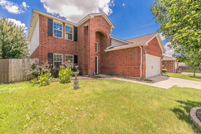 view of front of home featuring a garage and a front lawn