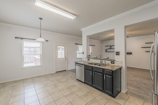 kitchen with light stone countertops, sink, stainless steel appliances, decorative light fixtures, and ornamental molding