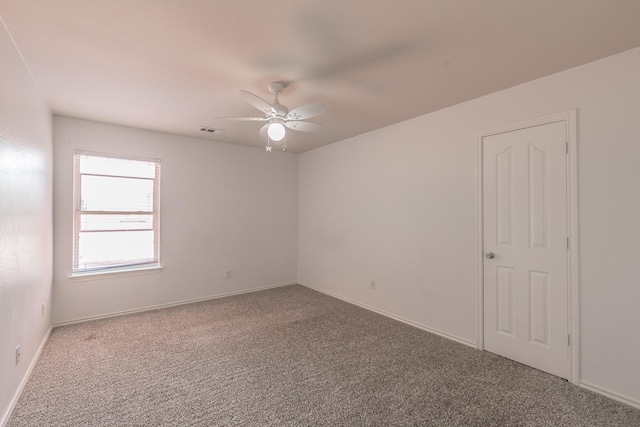 empty room with ceiling fan and carpet