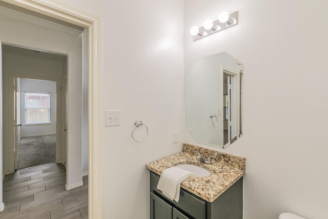 bathroom featuring vanity and ornamental molding