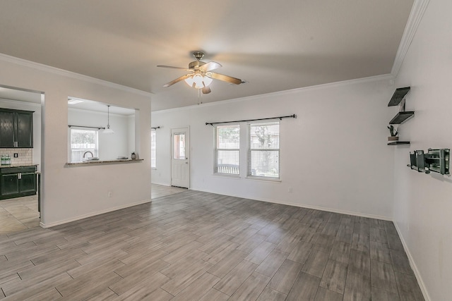 living room with ceiling fan, sink, and crown molding