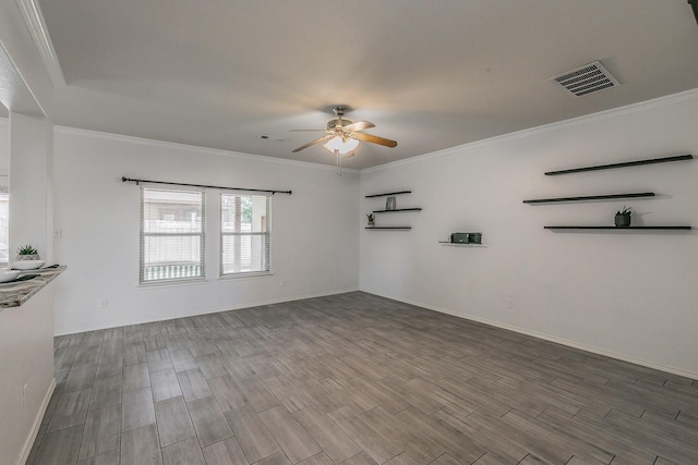 spare room with ceiling fan and crown molding