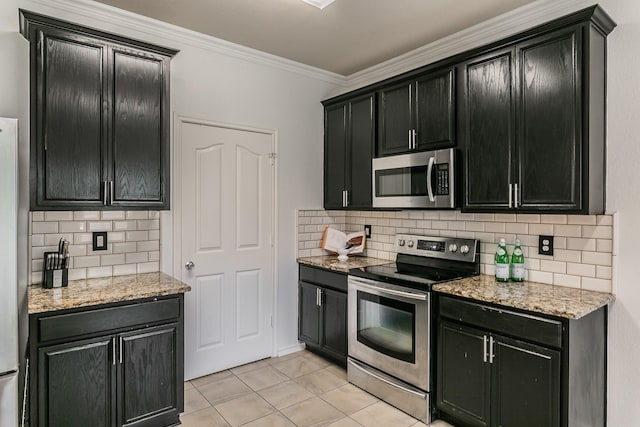 kitchen with backsplash, crown molding, light tile patterned flooring, and appliances with stainless steel finishes