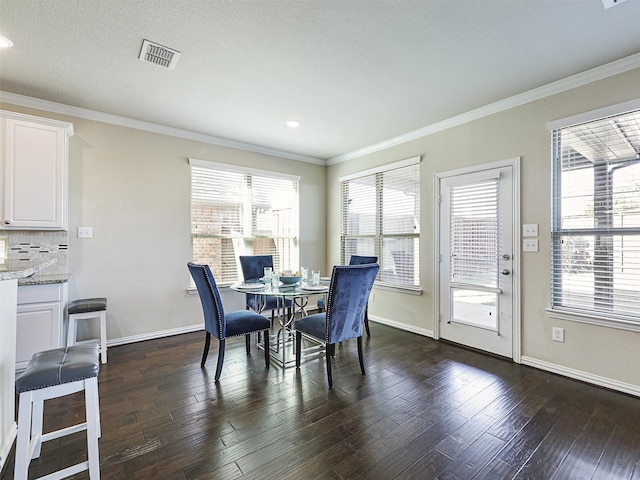 dining room with dark hardwood / wood-style flooring and ornamental molding