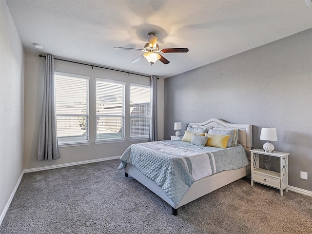 bedroom featuring multiple windows, dark colored carpet, and ceiling fan