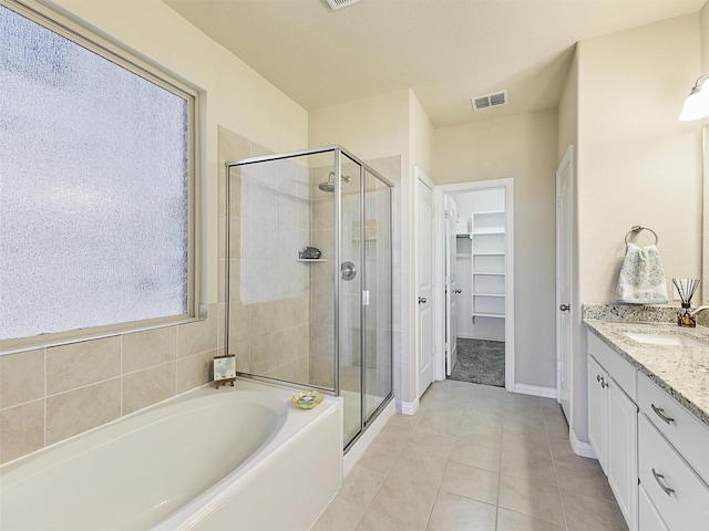 bathroom with tile patterned floors, vanity, and separate shower and tub