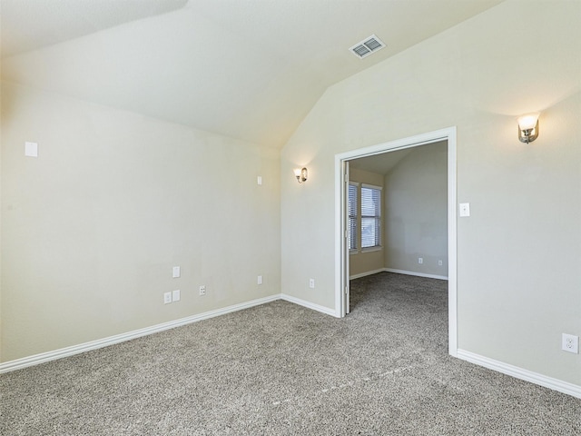 unfurnished room featuring carpet and lofted ceiling