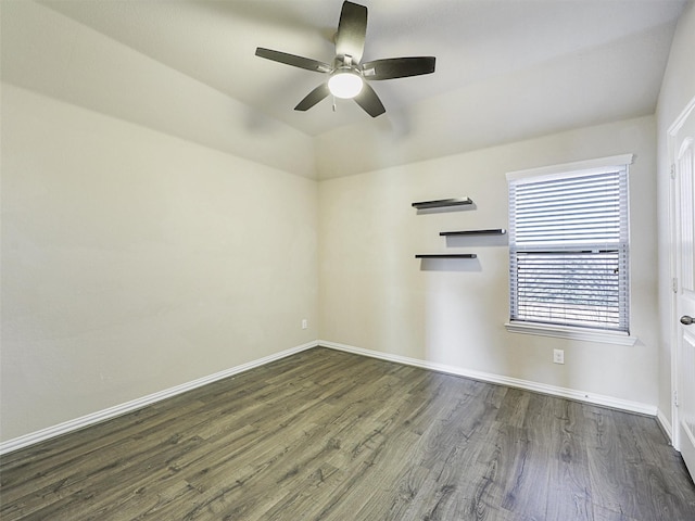 spare room with ceiling fan and dark wood-type flooring