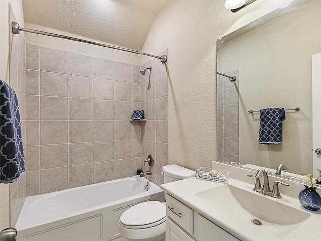 full bathroom with vanity, tiled shower / bath combo, vaulted ceiling, and toilet