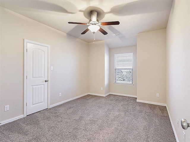 spare room featuring carpet floors and ceiling fan