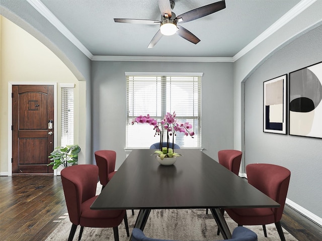 dining room with ornamental molding, ceiling fan, and dark wood-type flooring