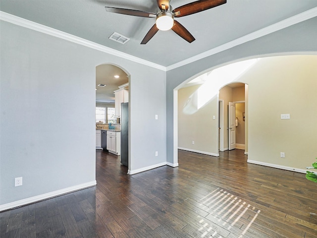 empty room featuring dark wood-type flooring, ceiling fan, and crown molding