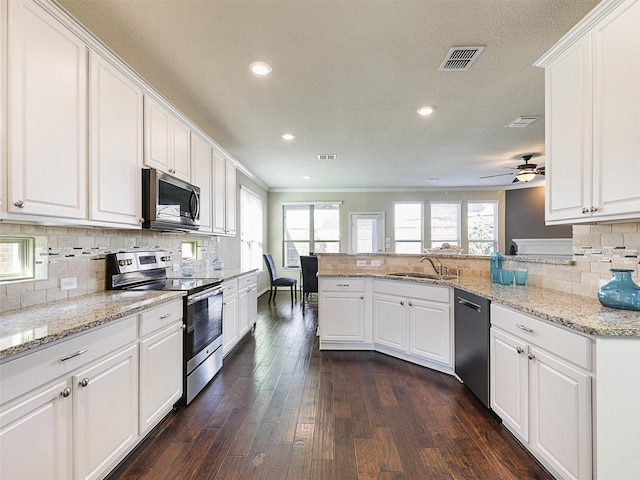 kitchen featuring sink, white cabinetry, kitchen peninsula, and appliances with stainless steel finishes