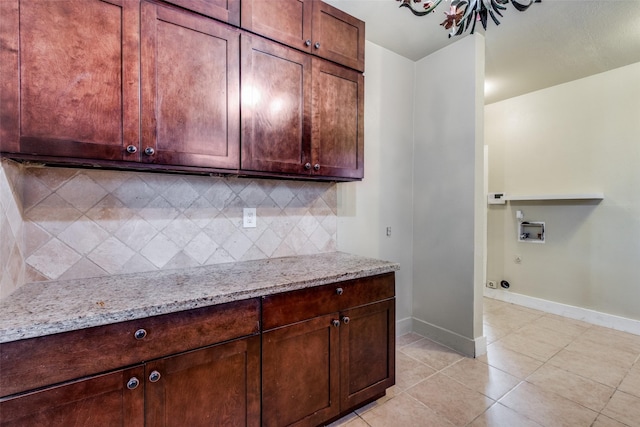 kitchen with light stone countertops, backsplash, and light tile patterned flooring