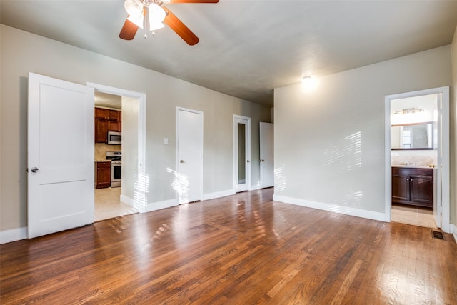 unfurnished room with ceiling fan and light wood-type flooring