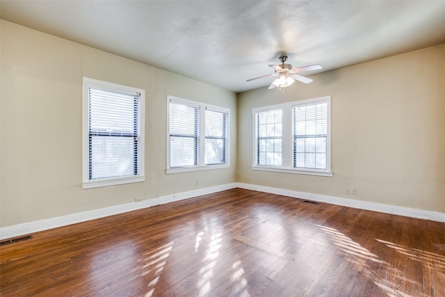 empty room featuring hardwood / wood-style flooring and ceiling fan