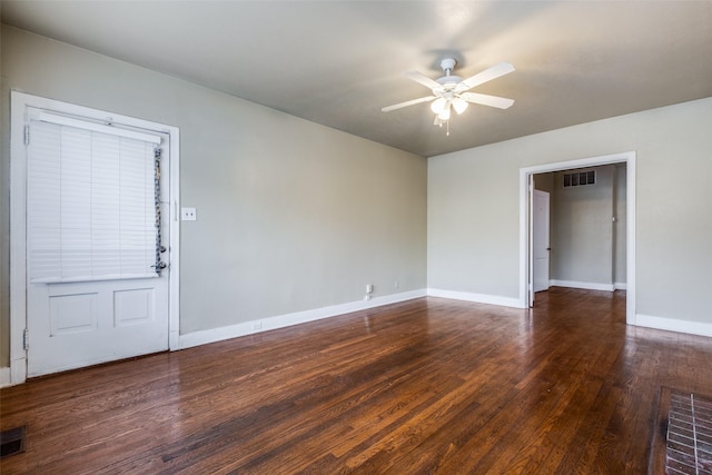 empty room featuring dark hardwood / wood-style flooring and ceiling fan