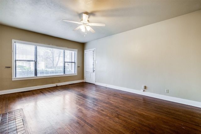 spare room with ceiling fan and dark hardwood / wood-style flooring