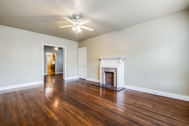 unfurnished living room featuring ceiling fan, a fireplace, and dark wood-type flooring