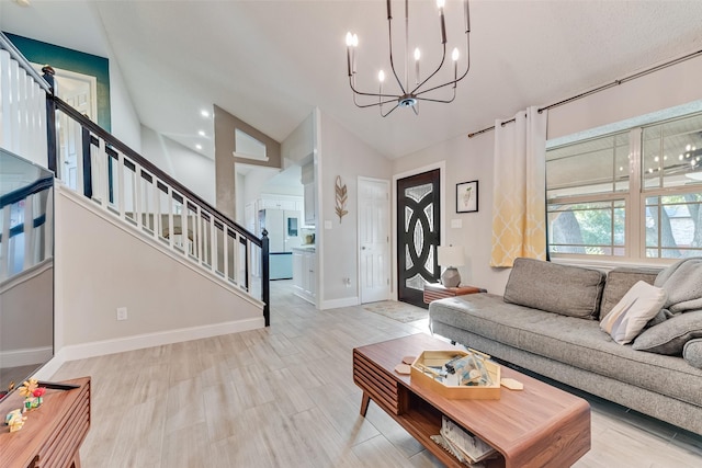 living room featuring high vaulted ceiling, a notable chandelier, and light wood-type flooring