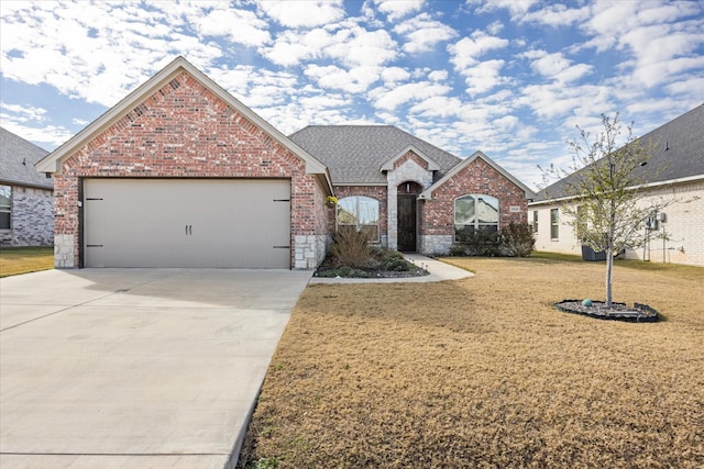 view of front of house with a garage and a front lawn