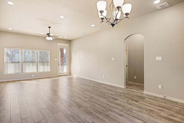 spare room featuring light hardwood / wood-style flooring and ceiling fan with notable chandelier