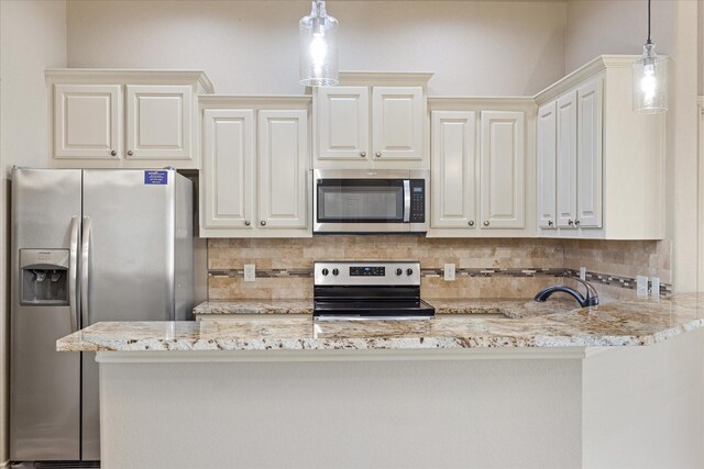 kitchen featuring backsplash, decorative light fixtures, and appliances with stainless steel finishes