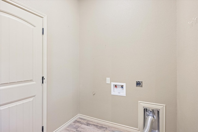 clothes washing area featuring electric dryer hookup, gas dryer hookup, light wood-type flooring, and hookup for a washing machine