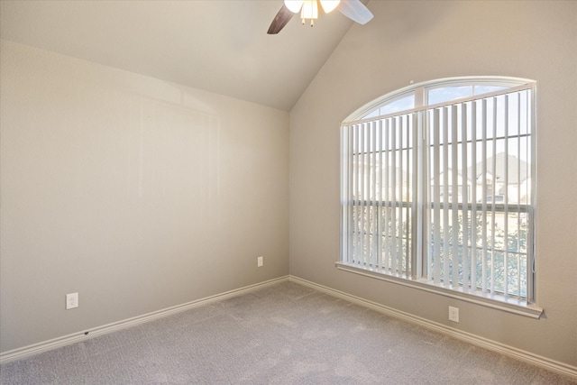 unfurnished room featuring ceiling fan, carpet floors, and vaulted ceiling