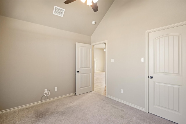 unfurnished bedroom with ceiling fan, light colored carpet, and high vaulted ceiling