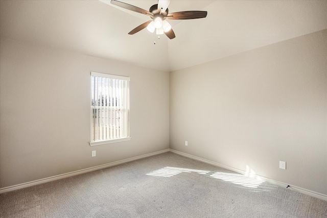 empty room featuring carpet flooring, ceiling fan, and lofted ceiling