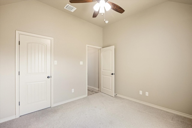 unfurnished bedroom featuring ceiling fan, lofted ceiling, and light carpet