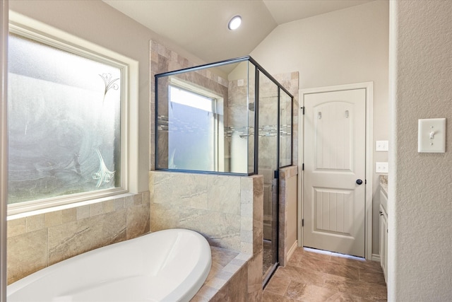 bathroom featuring vanity, independent shower and bath, and a wealth of natural light