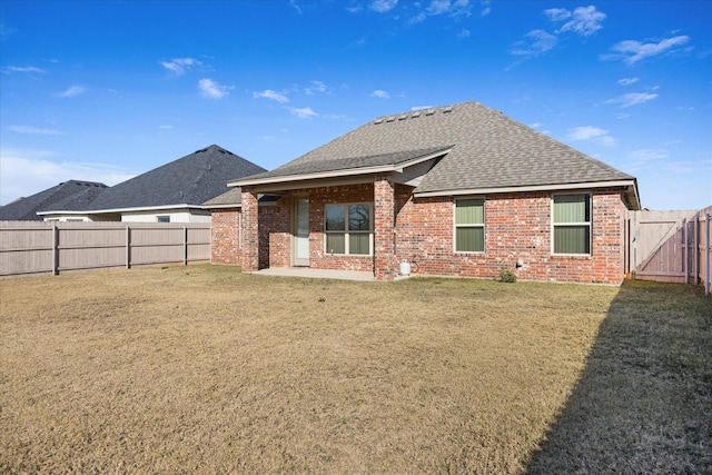 rear view of house with a lawn