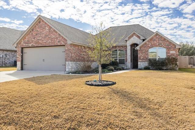 view of front of home with a front lawn and a garage