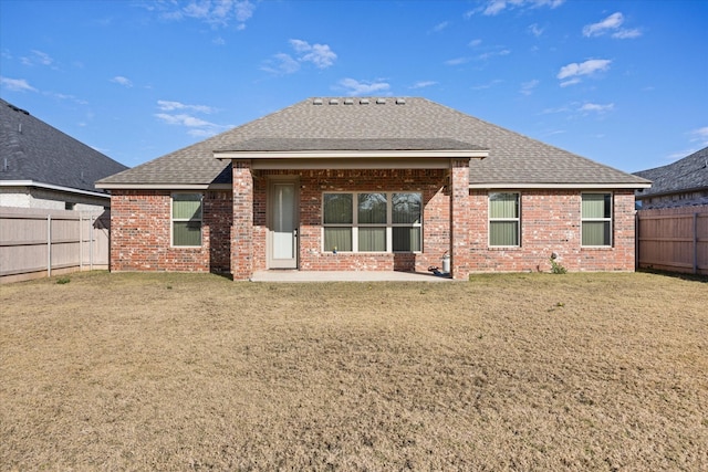 back of house with a lawn