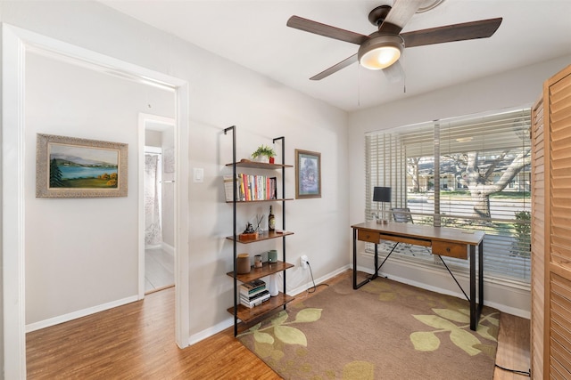 office with wood-type flooring and ceiling fan