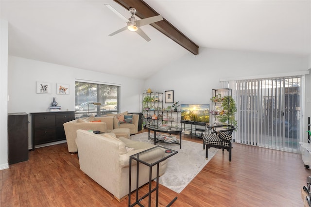 living room featuring hardwood / wood-style floors, ceiling fan, and lofted ceiling with beams