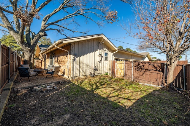 view of side of home featuring a yard